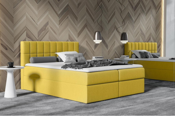 Roze stoffen boxspringbed met textielontwerp, modern tweepersoons hotelbed met opbergruimte.