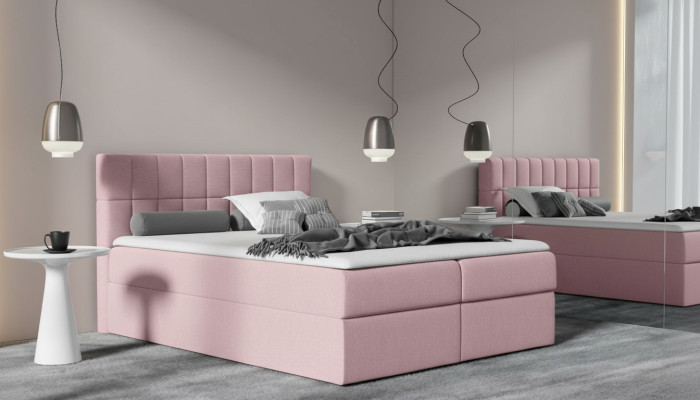 Roze stoffen boxspringbed met textielontwerp, modern tweepersoons hotelbed met opbergruimte.
