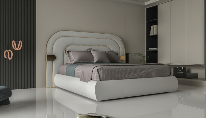 Luxe grijze bedframe met gouden details in modern ontwerp en zachte hoofdeinde