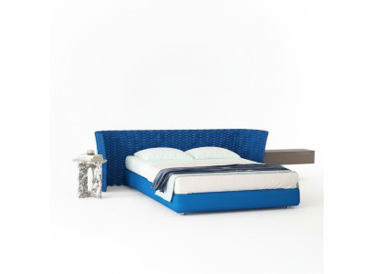 Blau stoffen bed met gestoffeerde hoofdeinde